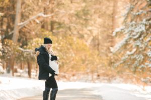 Pregnant woman standing on road in the snow at Hartwood Acres Mansion near Pittsburgh