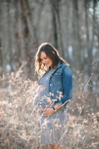 Pregnant woman standing in field at North Park near Pittsburgh