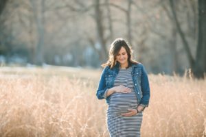 Pregnant woman standing in field at North Park near Pittsburgh