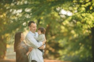 Dad holding baby boy in hand at Mellon Park near Pittsburgh