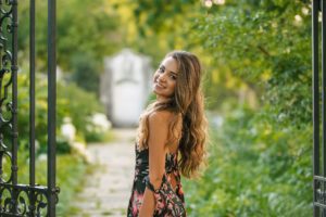 High school senior girl looking over shoulder at Mellon Park near Pittsburgh