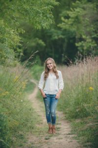 High school senior girl standing on path at Sewickley Heights Borough Park near Pittsburgh