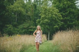 High school senior girl standing on path at Sewickley Heights Borough Park near Pittsburgh
