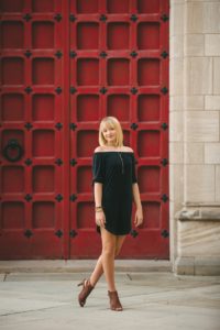 High school senior girl standing in front of red door at the Cathedral of Learning near Pittsburgh