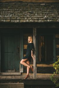 High school senior girl standing in front of cabin at the Cathedral of Learning near Pittsburgh
