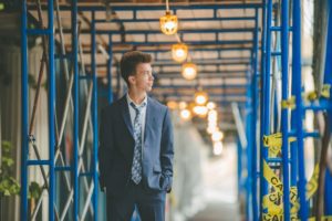 High school senior boy standing in construction site in downtown Pittsburgh