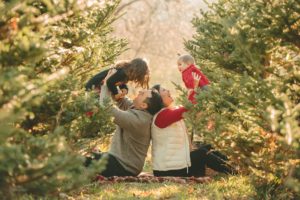 Mom and dad holding up children at Nutbrown's Christmas Tree Farm near Pittsburgh