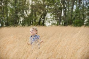Toddler boy standing in field in Moon Township near Pittsburgh