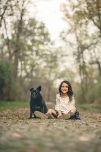 Girl sitting next to dog at Sewickley Heights Borough Park near Pittsburgh