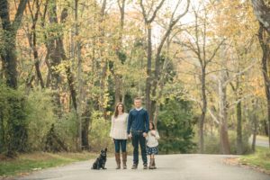 Family standing on road with dog at Sewickley Heights Borough Park near Pittsburgh