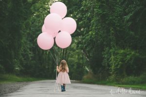 Girl holding balloon in Sewickley Heights Borough Park near Pittsburgh