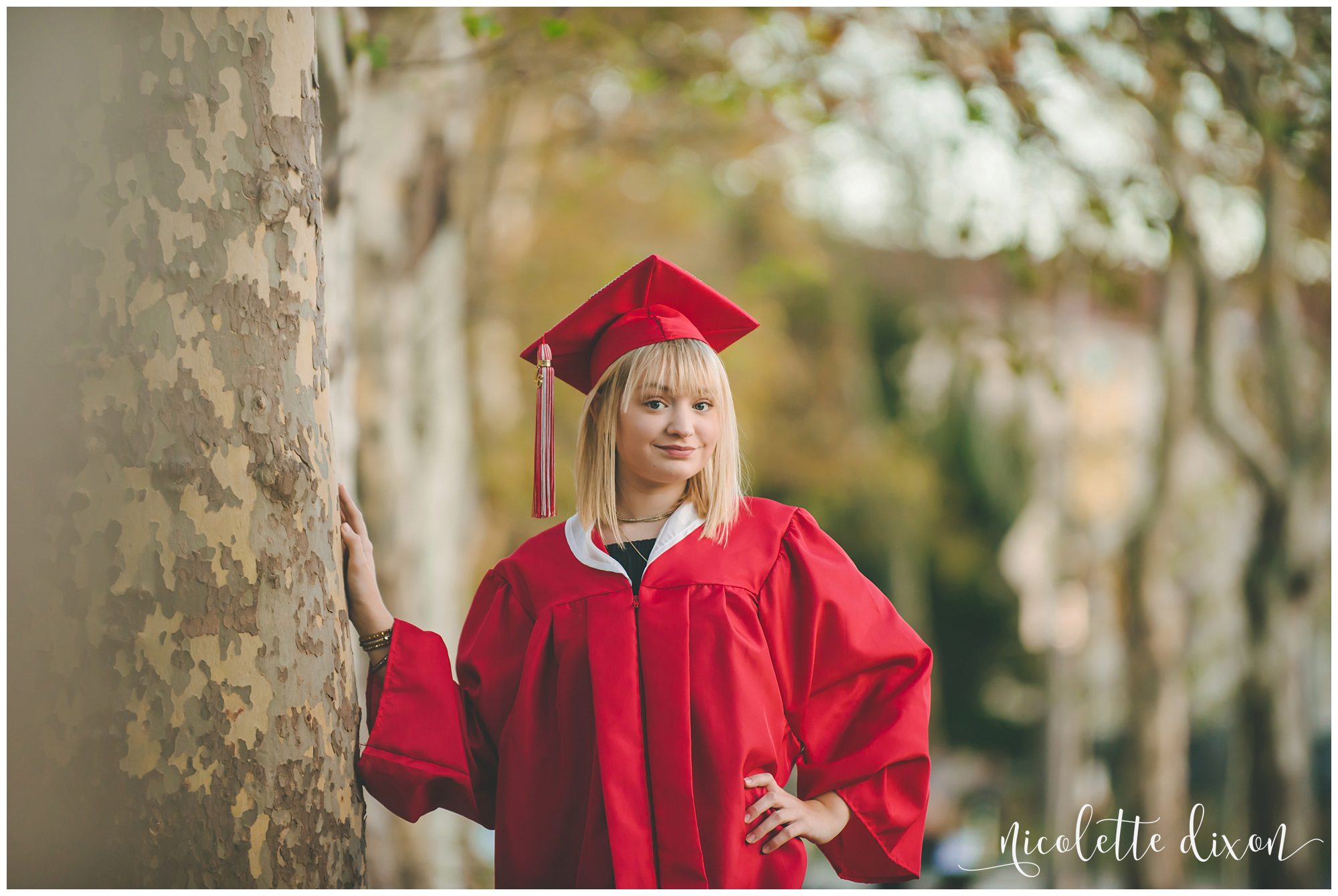 Senior girl wearing graduation cap and gown in Schenley Park near Pittsburgh