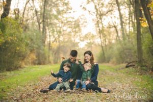 Family throwing leaves into the air at Sewickley Heights Borough Park near Pittsburgh