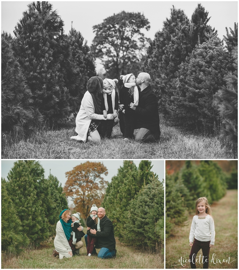 Mom and dad kissing their girls at Allison's Christmas Trees near Pittsburgh