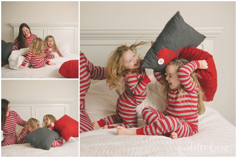 Sisters wearing matching Christmas pajamas and having a pillow fight in home near Moon Township near Pittsburgh