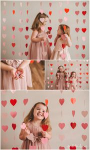 Sisters Playing in Heart Shaped Valentine's Day Garland