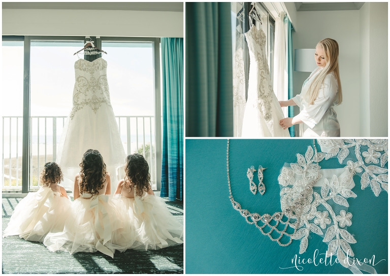 Flower girls sitting on the floor looking at wedding dress