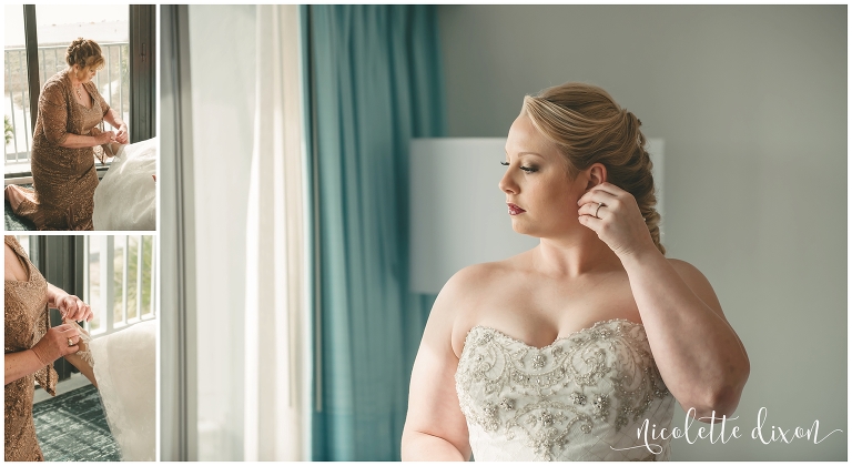 Bride putting on her earrings for beach wedding