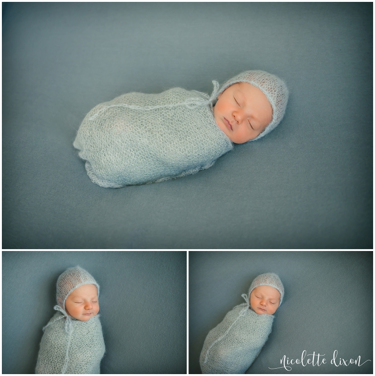 Newborn baby boy wearing blue bonnet in studio in Moon Township near Pittsburgh