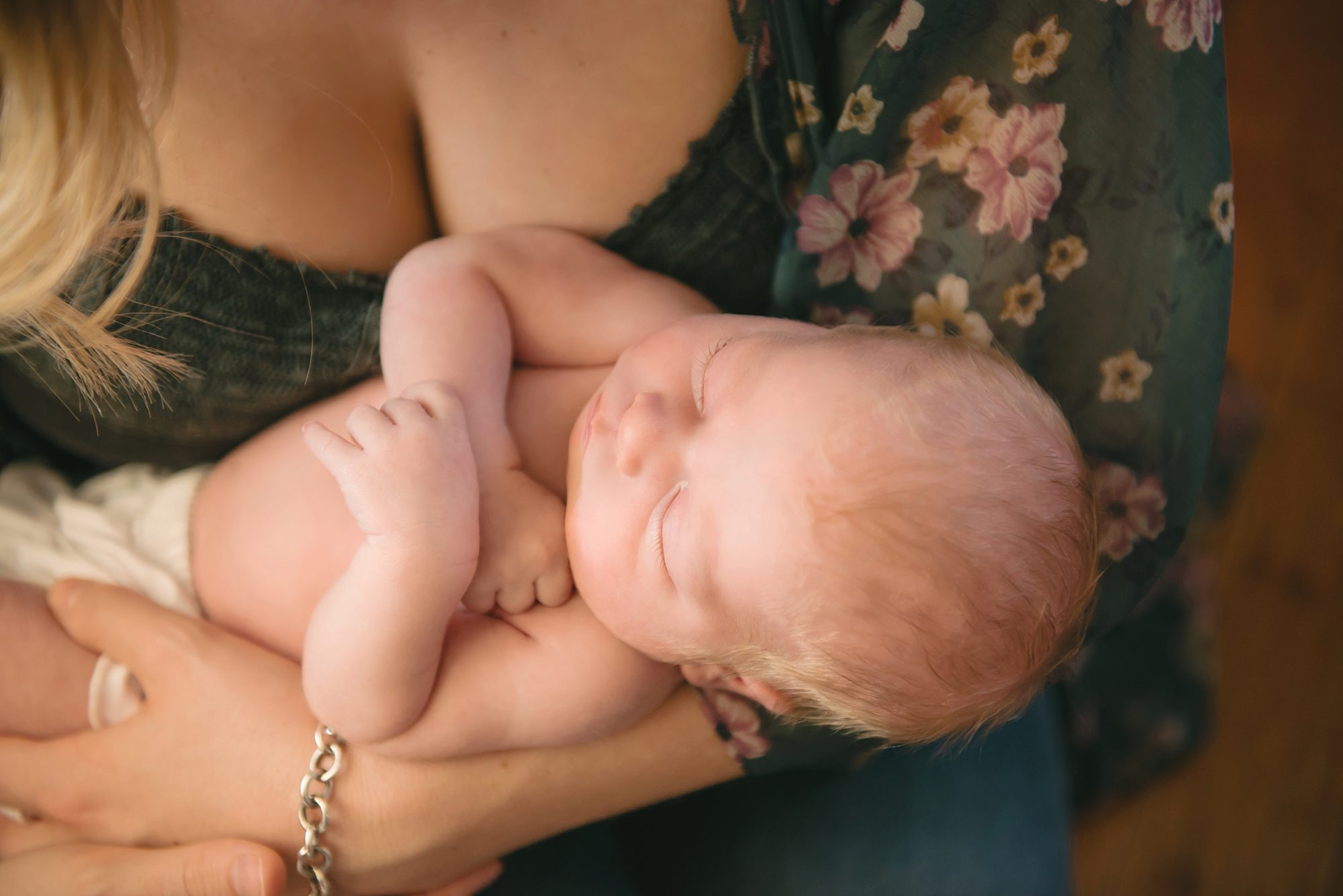 Mom holding newborn baby girl in home in Sewickley near Pittsburgh