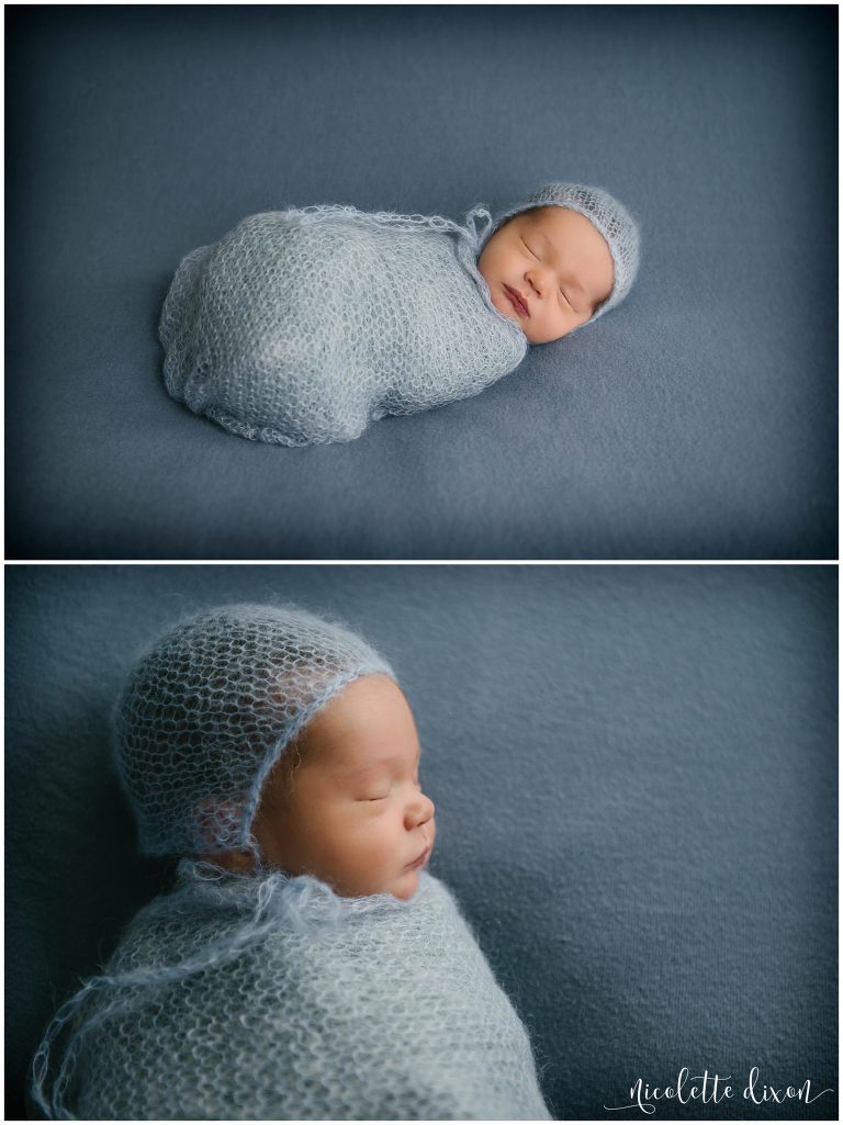 Infant baby boy wrapped in blue blanket and bonnet in photography studio in Moon Township near Pittsburgh