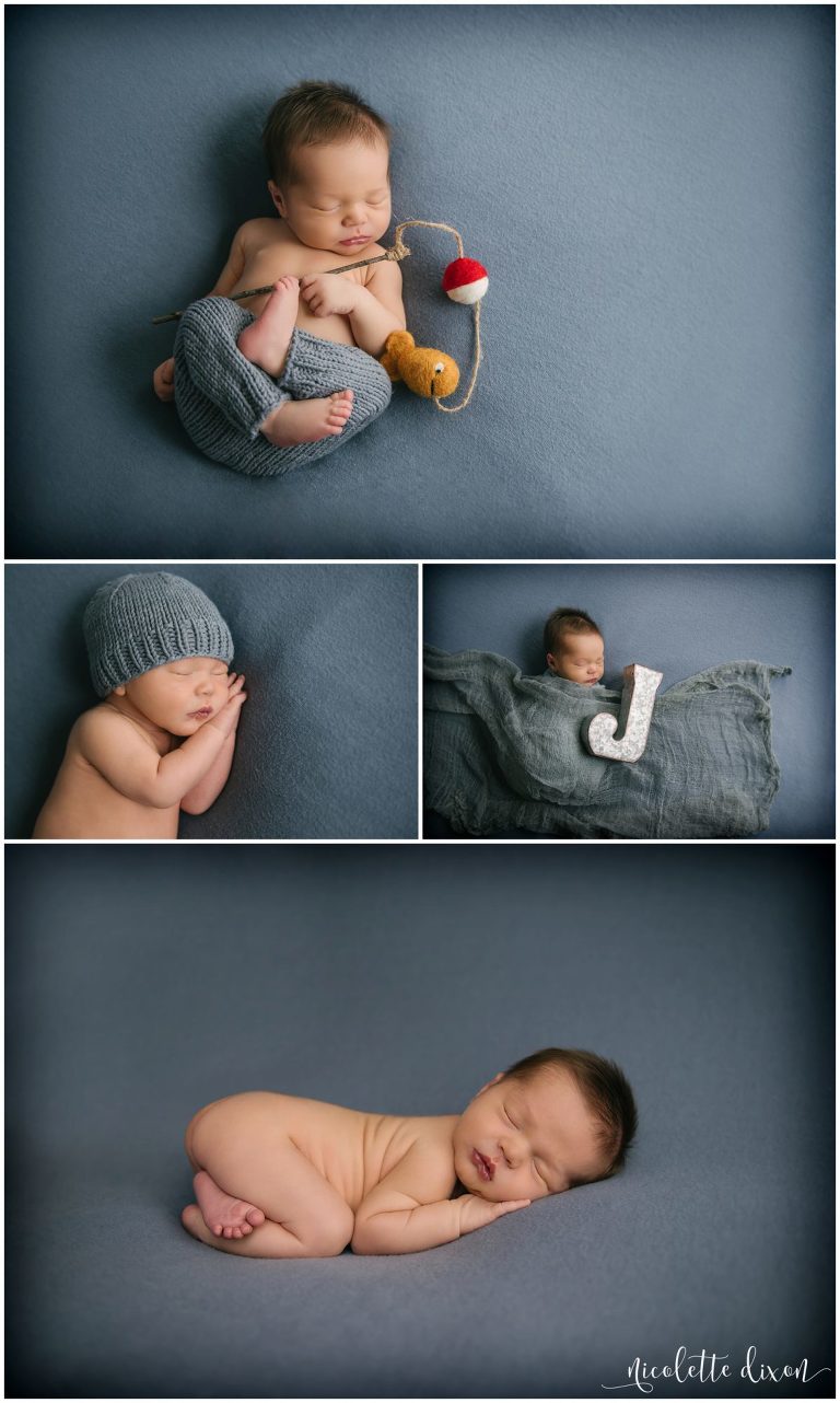 Infant baby boy laying on blue blanket with fishing pole at photography studio in Moon Township near Pittsburgh