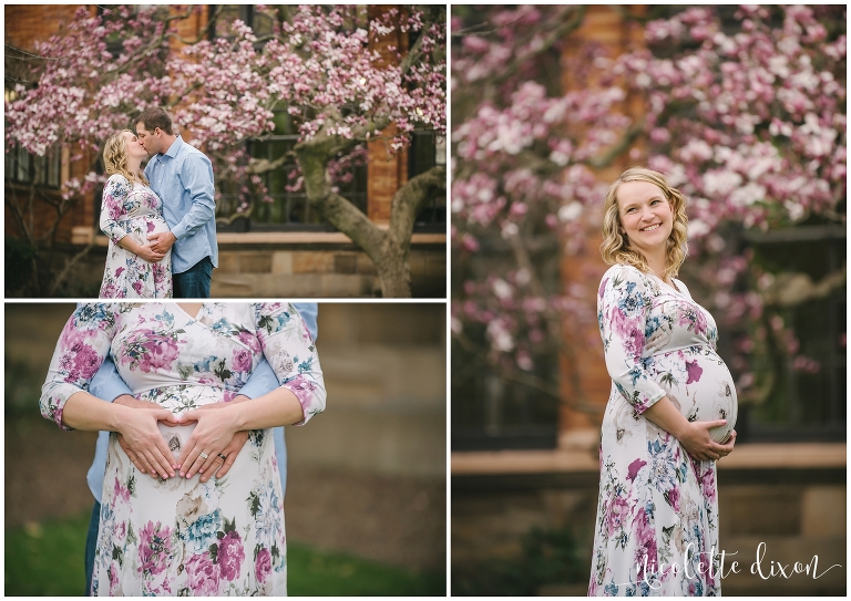 Pregnant woman holding belly in front of magnolia tree at the University of Pittsburgh near Pittsburgh