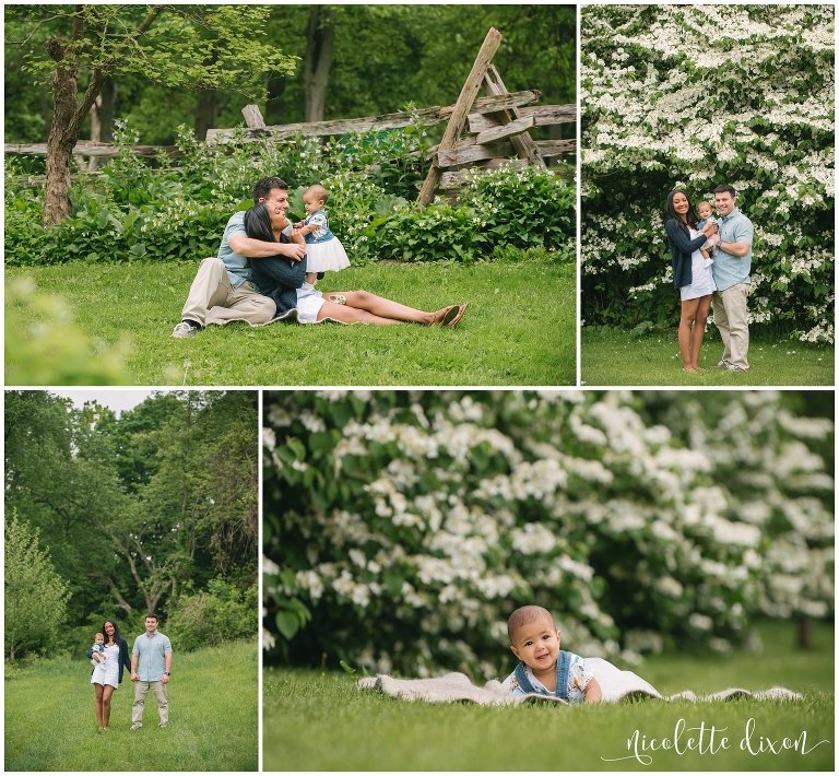 Mom and dad sitting on the ground looking at baby at Oliver Miller Homestead in South Park near Pittsburgh