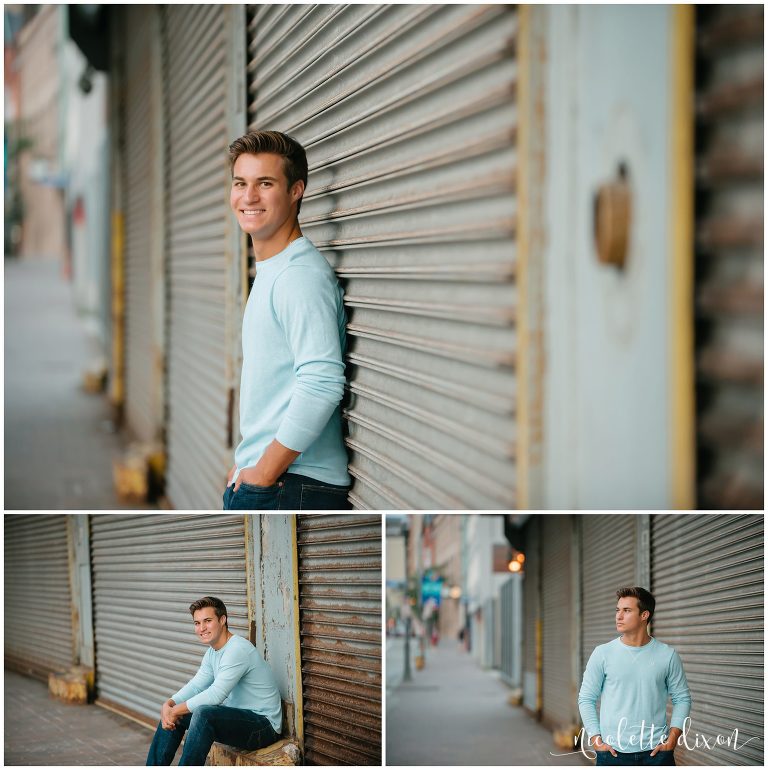 Senior boy standing next to garage in downtown Pittsburgh PA