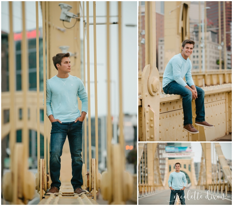 Senior boy standing on bridge in downtown Pittsburgh PA