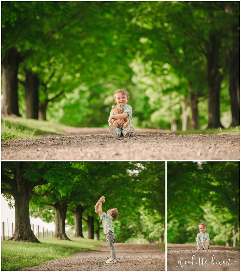 Young boy playing with teddy bear in Round Hill Park near Pittsburgh