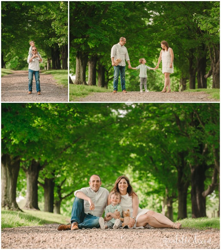 Family of three holding hands and sitting together at Round Hill Park near Pittsburgh