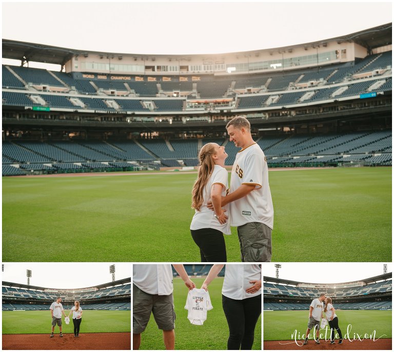 Man and woman wearing Pittsburgh Pirate jerseys and holding a onesie at PNC Park near Pittsburgh