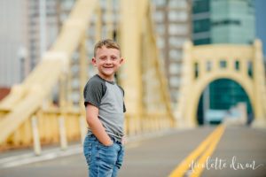 Boy Standing in the Middle of the Roberto Clemente Bridge in Downtown Pittsburgh