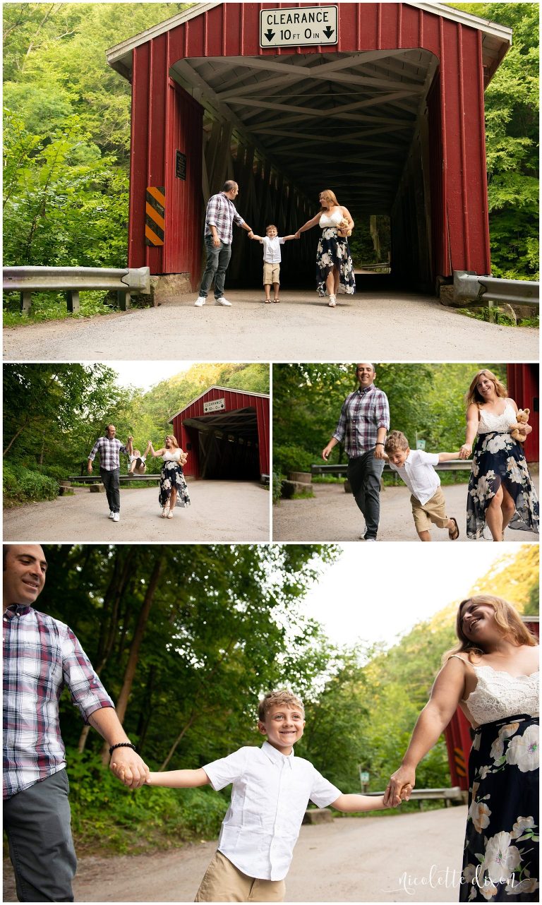 Family walking in front of covered bridge at McConnells Mill State Park near Pittsburgh