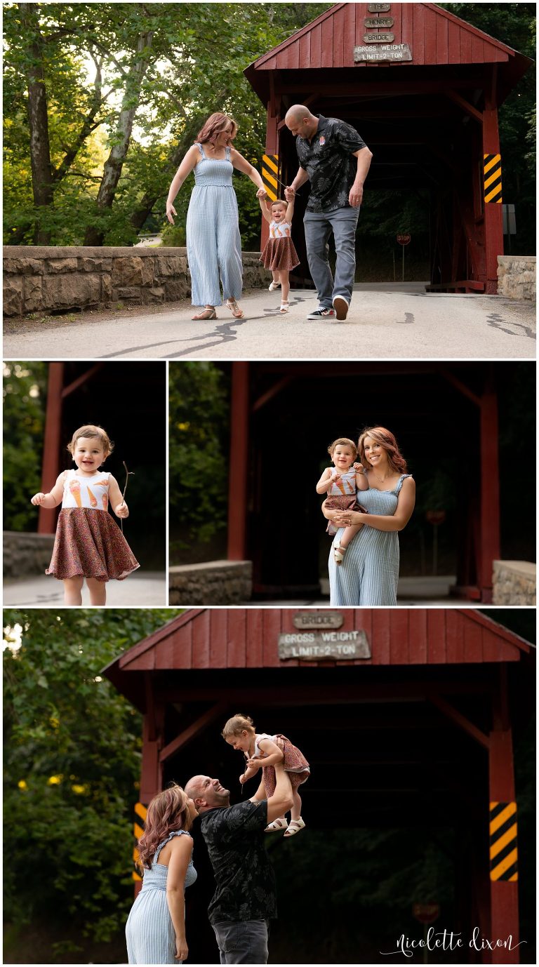 Family swinging daughter by red covered bridge at Mingo Creek County Park near Pittsburgh