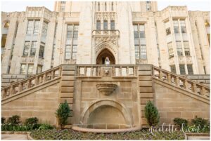 College grad standing in front of the Cathedral of Learning at the University of Pittsburgh
