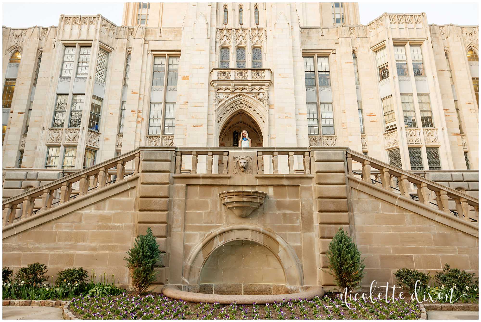 College grad standing in front of the Cathedral of Learning at the University of Pittsburgh