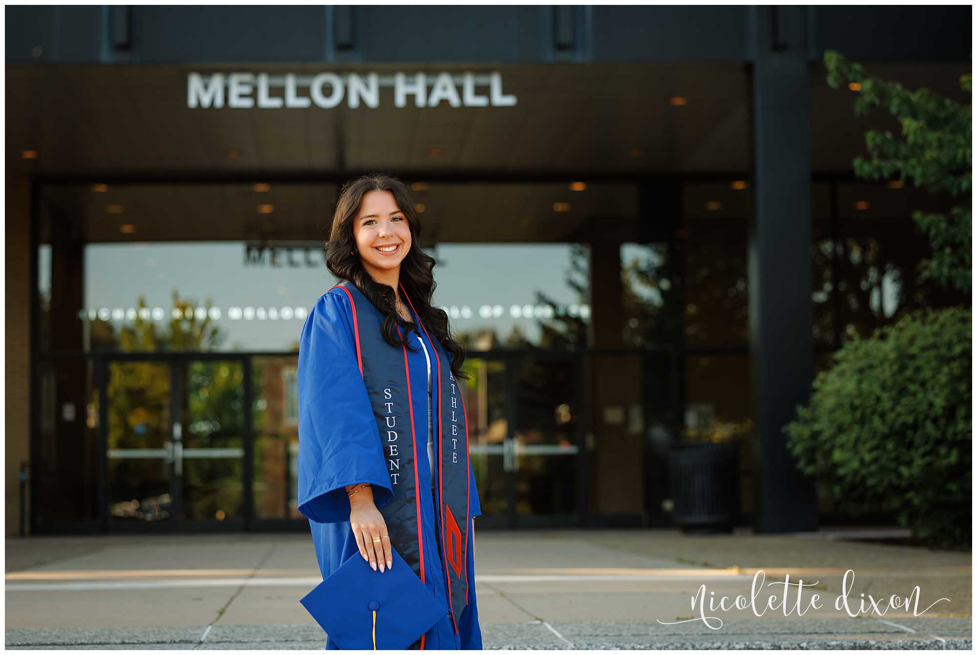 College Graduate Standing in Front of Mellon Hall on Duquesne University Campus in Pittsburgh