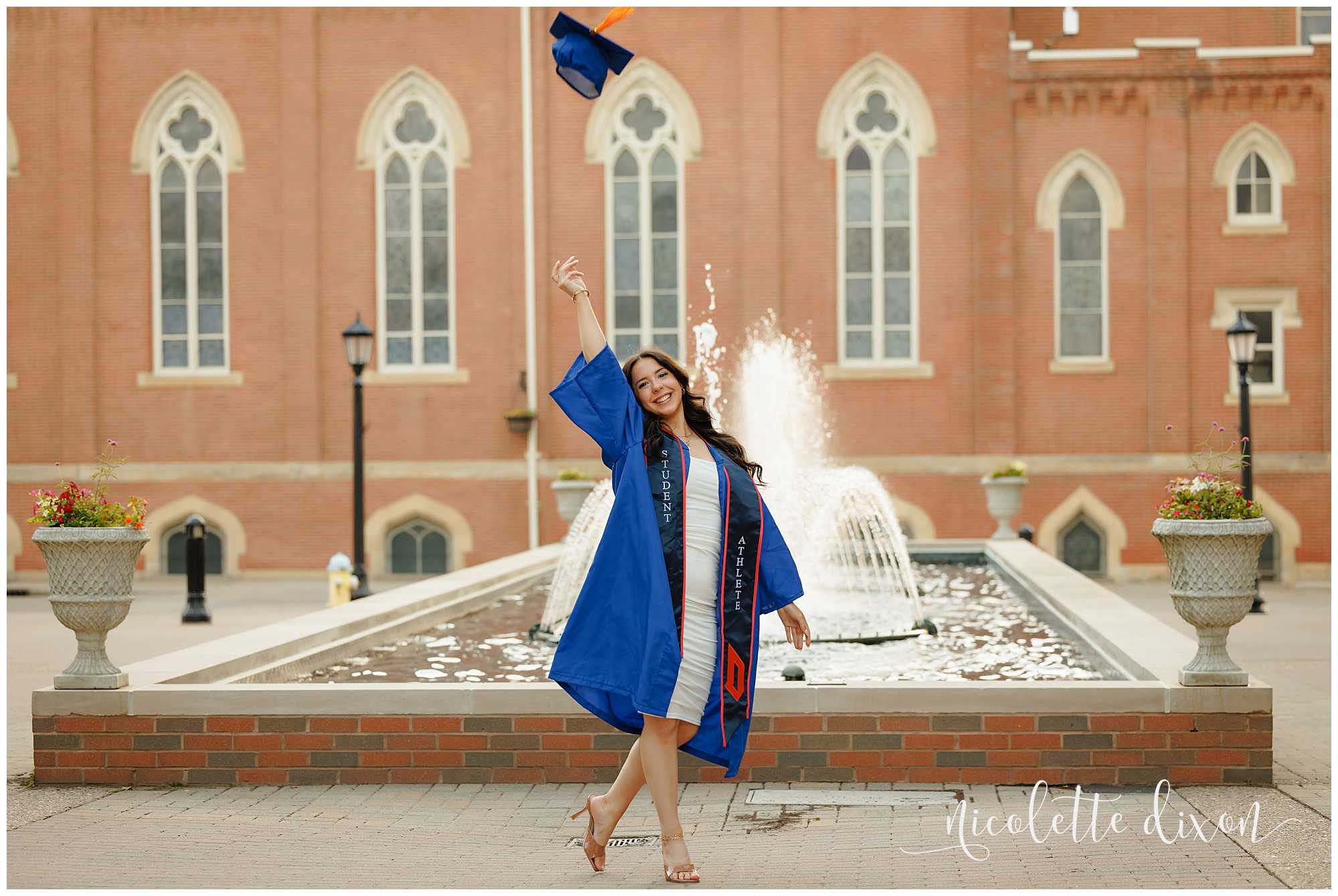 College Graduate Throwing Up Hat in Front of Fountain on Duquesne University Campus in Pittsburgh