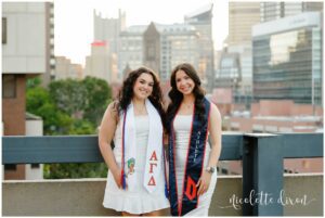 College Graduates Standing Together in front of City Skyline at Duquesne University Campus in Pittsburgh