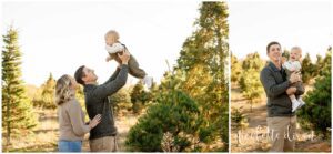 Dad holding up one year old baby at Aliison's Christmas Tree Farm near Pittsburgh PA