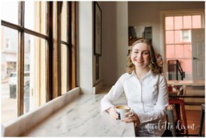 High School Senior Girl Standing Next to Window in Carnegie Coffee Company in Carnegie near Pittsburgh PA