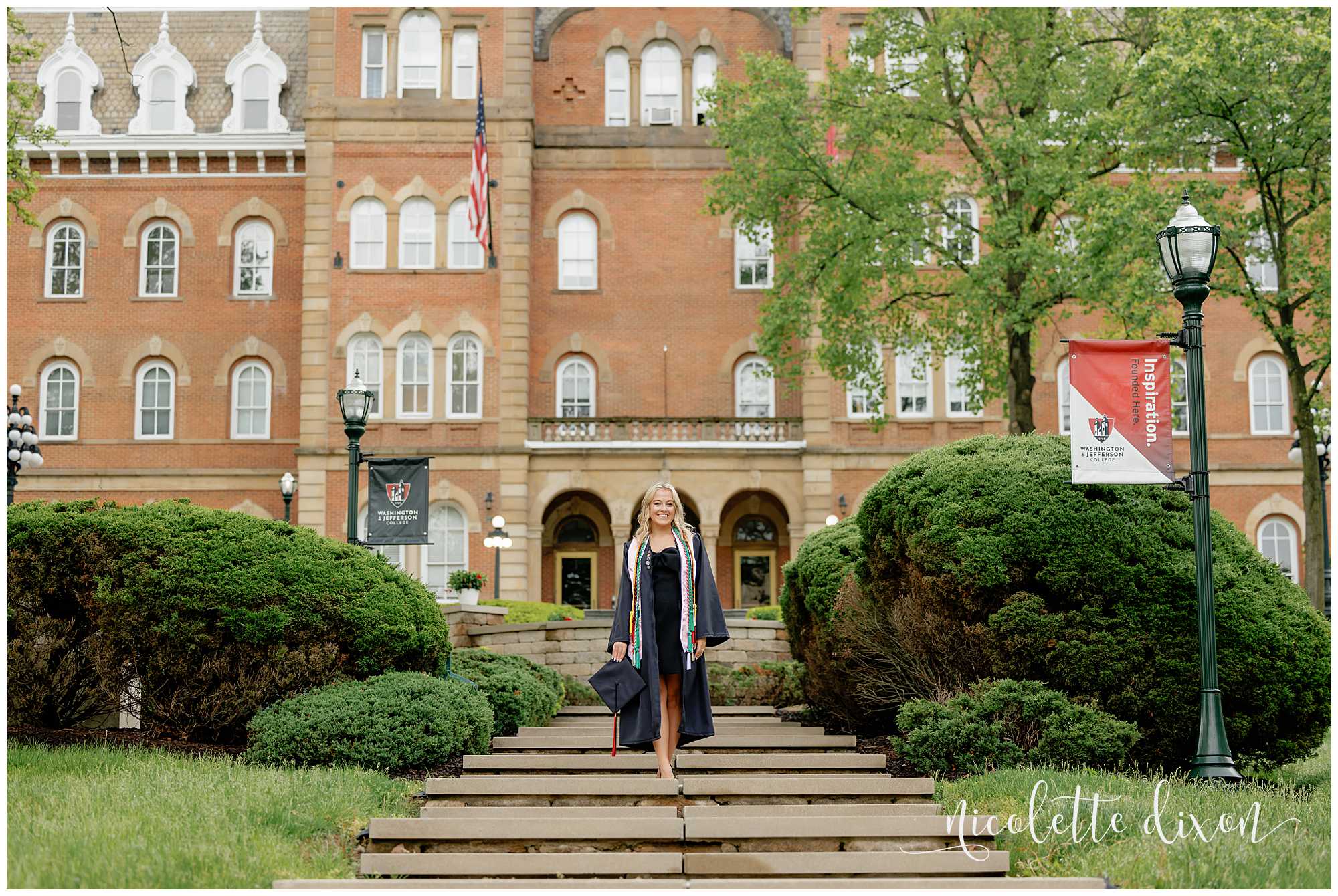 College grad standing in front of Old Main at Washington and Jefferson College near Pittsburgh