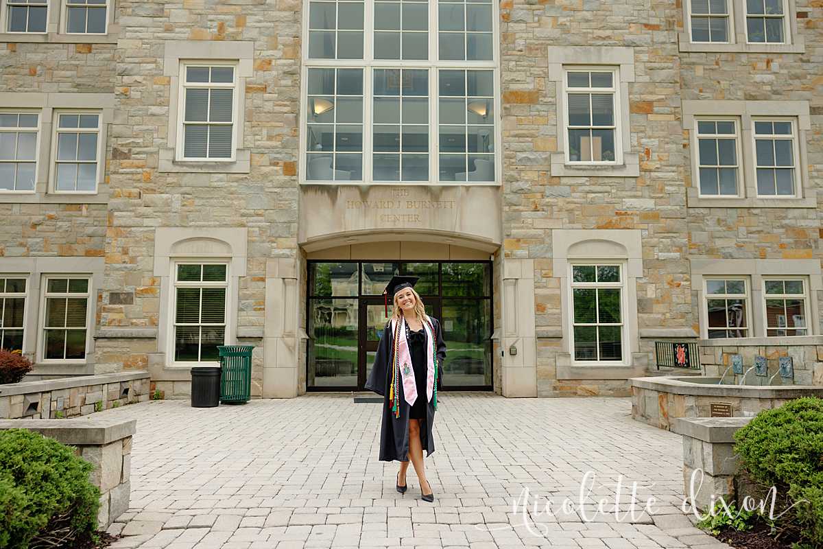 College grad standing in front of Burnett Center at Washington and Jefferson College near Pittsburgh