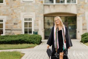 College grad standing in front of Burnett Center at Washington and Jefferson College near Pittsburgh