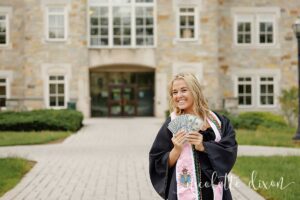 College grad holding money in front of Burnett Center at Washington and Jefferson College near Pittsburgh