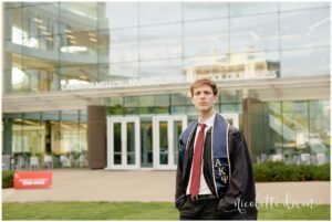 College Graduate Standing in Front of Tepper School of Business at Carnegie Mellon University in Pittsburgh PA